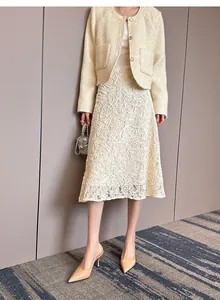 Sophisticated beige patent leather slingback high heels styled with an elegant lace midi skirt