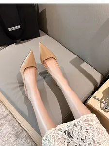 Elegant nude patent leather slingback pumps with a sleek stiletto pointed toe design.