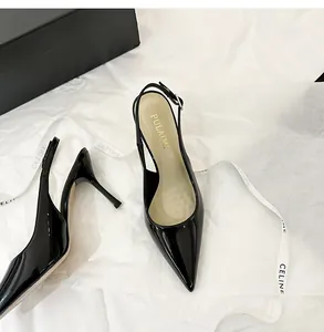 Elegant black patent leather slingback heels with pointed toe in luxury packaging