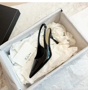 Elegant black patent leather slingback pointed toe stiletto heels in a white gift box
