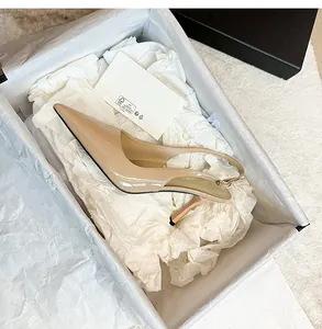 Elegant nude patent leather pointed toe slingback high heel shoe in a gift box