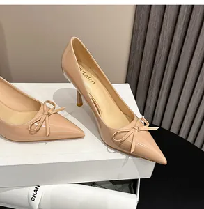 Detailansicht eleganter nudefarbener Lackleder-Pumps mit spitzer Kappe und schicker Schleife