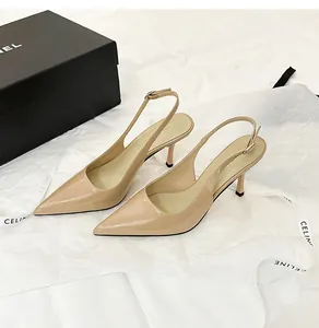 Elegant detail of beige patent leather pointed toe slingback high heel shoes on display