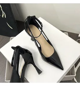 Elegant black patent leather pointed toe pumps with ankle strap and cutout design