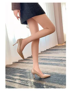 Side view of elegant nude patent leather pointed-toe pumps with high stiletto heels