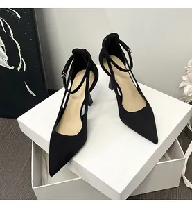 Elegant black pointed-toe high heels with adjustable ankle straps and side cutouts.