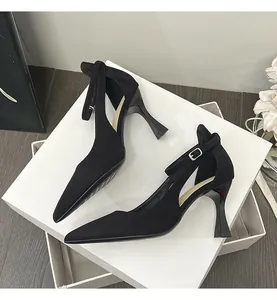 Elegant black pointed-toe high heels featuring ankle straps and chic cut-out details