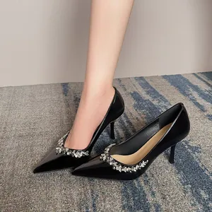 Elegant black patent leather pointed toe heels with rhinestone flower for weddings