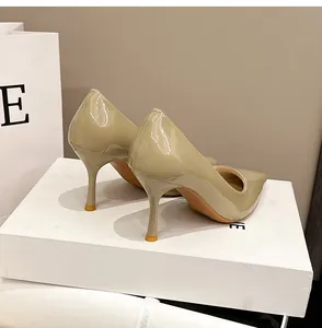 Detailansicht der beigen Lackleder-Stilettos mit spitzer Kappe und hohen Absätzen.