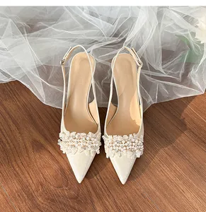 Close-up of elegant bridal shoes featuring luxury pearl and rhinestone embellishments