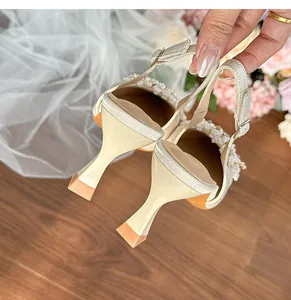Detailed view of the elegant pointed-toe bridal heels with pearl and rhinestone accents