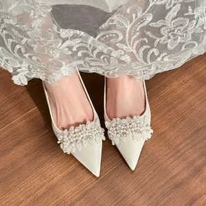 Elegant white satin pointed-toe bridal high heels with exquisite pearl and rhinestone cluster
