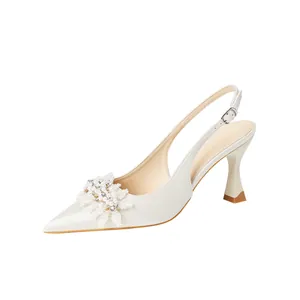 Elegant off-white satin pointed-toe bridal slingbacks with pearl floral detail and high heel