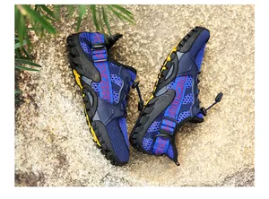 Detail shot of blue breathable mesh outdoor water shoes on a natural stone surface