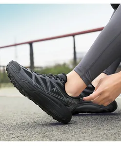 Detailed view of black chunky athletic running shoes with breathable mesh and thick soles