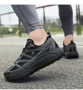 Close-up of breathable black dad shoes with thick anti-slip sole on asphalt surface.