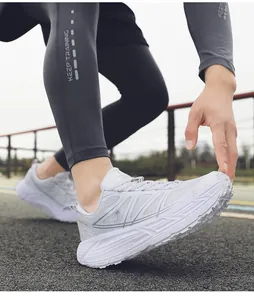 Side view detail of white breathable thick-sole sneakers worn for outdoor running.