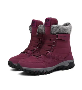 Detail of burgundy winter snow boots featuring grey faux fur and rubber soles