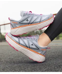 Side view of breathable chunky running shoes with grey mesh and vibrant pink soles