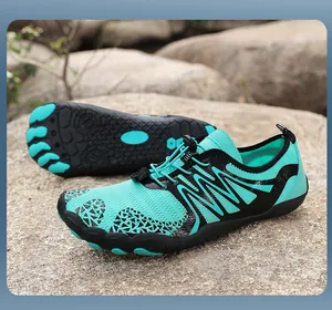Close-up of cyan quick-dry breathable mesh water shoes with anti-slip soles on rocks