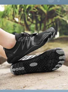 Detailed macro view of breathable black outdoor water shoes with non-slip rubber sole