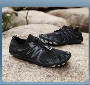 Detailed view of black breathable quick-dry wading shoes on natural rock surface.