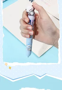 Close-up of a cute cartoon sea otter multi-color ballpoint pen held in a hand.