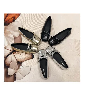 Detail view of large size ballet flats with bow and cross straps in gold, silver, and black