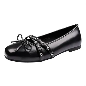 Black Mary Jane ballet flats with bow and criss-cross grommet straps for women.