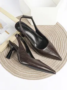 Close-up of brown crinkle leather slingback heels with elegant pointed toe