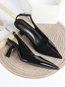 Elegant black pointed-toe slingback heels with patent and suede finish