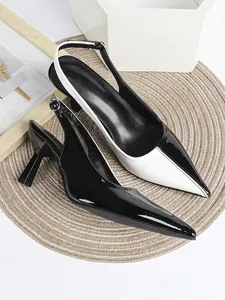 Detailed view of two-tone black and white pointed toe slingback high heel shoes
