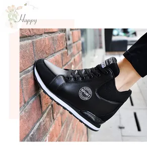 Detailed side view of stylish black high-top sneakers with hidden wedge for women