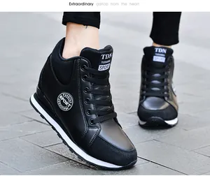 Close-up view of stylish black women's wedge sneakers with a hidden heel design