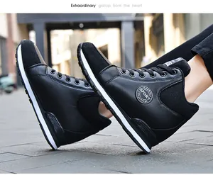 Side view of black high-top platform sneakers for women in urban street setting