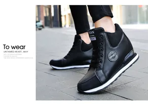 Close-up of fashionable black hidden wedge high-top sneakers for women on city street