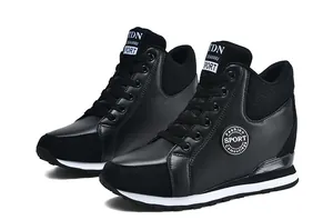 Side view of black hidden wedge sneakers for women featuring leather and suede textures.