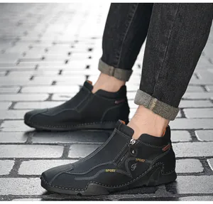 Close-up detail of black leather high-top sneaker featuring functional side zipper design