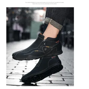 Close-up view showing the textured leather and side zipper detail of the black high-top shoe