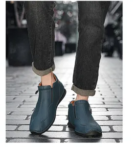 Detail view of stylish blue leather high-top shoes featuring side zipper and sporty sole