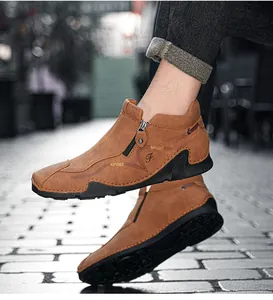 Detail view of brown high-top leather shoes with zipper and sport lettering