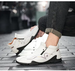 Close-up detail of stylish white high-top leather shoes with zipper on urban pavement