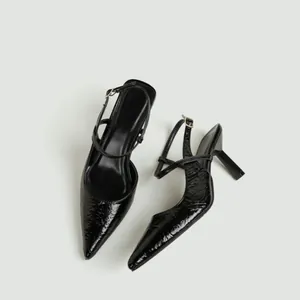 Vista dettagliata di scarpe slingback in pelle verniciata nera con punta molto affilata