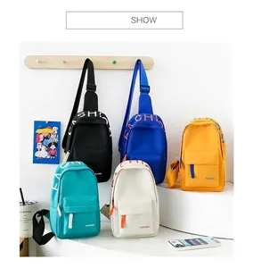 Various colors of trendy kids' fabric chest bags with stylish letter print display.