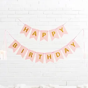 Detailed view of pink gold foil Happy Birthday swallowtail banner in party setting
