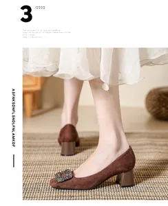 Close-up of brown suede block heel pumps with rhinestone square buckle detail