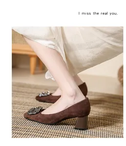 Elegant brown suede high heels with rhinestone buckle detail on thick heel pump