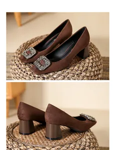 Close-up detail of brown suede chunky heels with square rhinestone buckle
