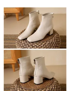 Detailed view of beige square-toe ankle boots with block heels and rear zipper closure.