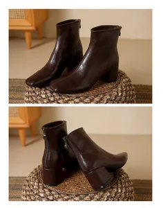 Detailed view of brown square-toe ankle boots with thick block heels and rear zippers